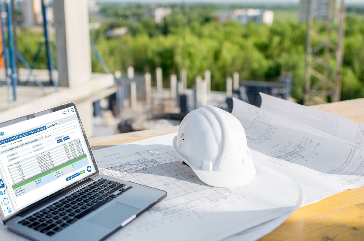 laptop at construction job site with virtual cards pulled up for remote approval