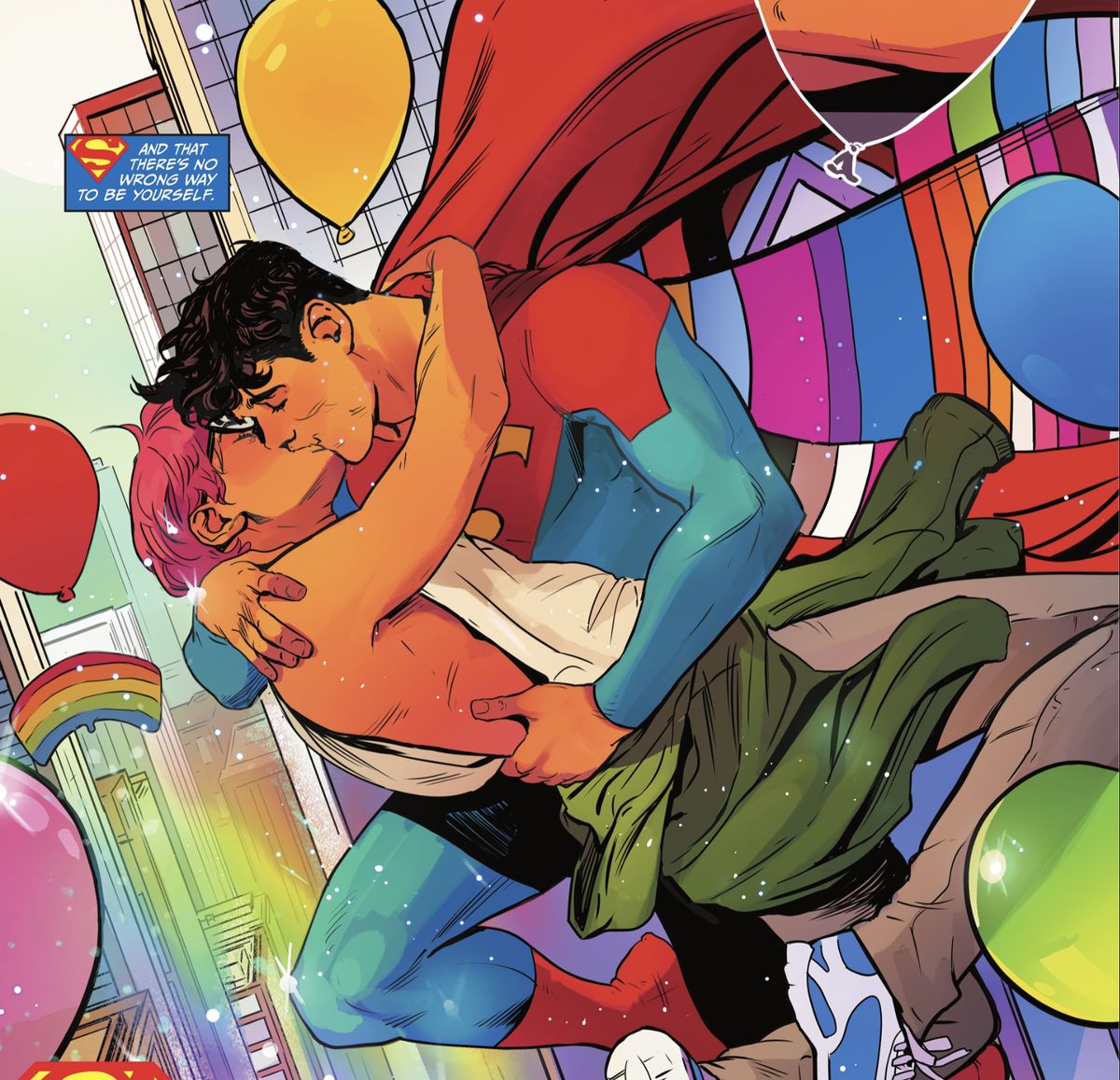 Jon Kent/Superman smooches his boyfriend Jay in mid air above a Gay Pride parade. Jon’s cape is lined with every different pride flag imaginable in DC Pride 2022. 