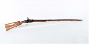 Spanish circa 1760 Miquelet musket fusil with a .69 bore at the flared muzzle, 51 inches long (the barrel 35 ½ inches), with an ornately carved walnut stock (est. $2,000-$3,000).