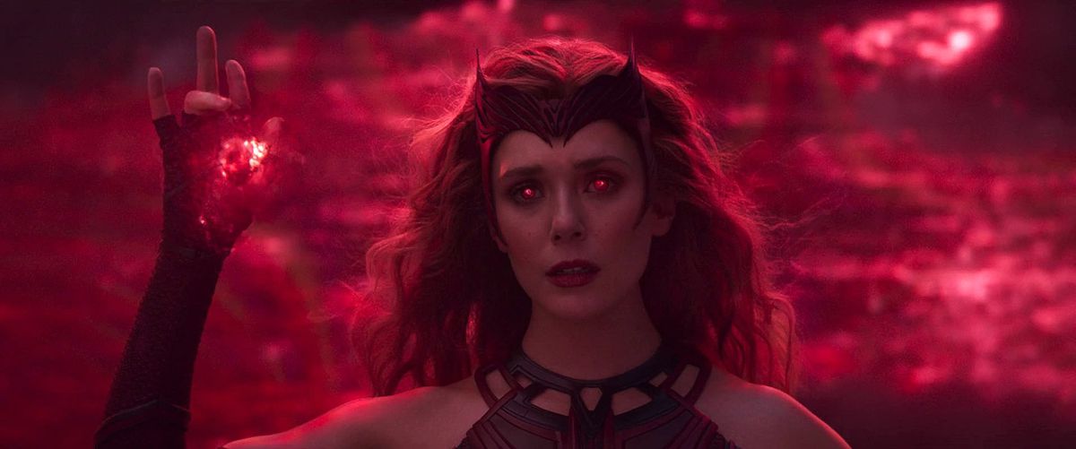 Wanda, eyes glowing red, conjuring a red spell while wearing a red crown in the WandaVision finale