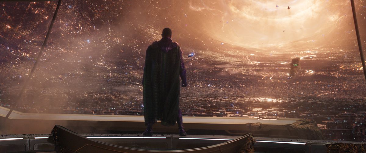 Kang the Conquerer (Jonathan Majors) stands with his back to the camera, looking through a vast window on his vast CGI city in Ant-Man and the Wasp: Quantumania