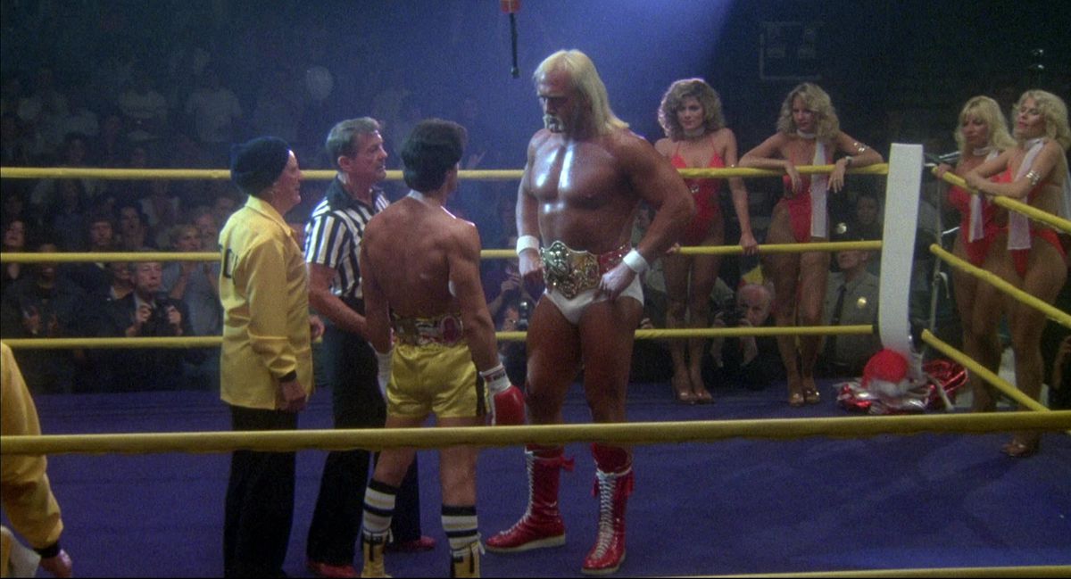 Hulk Hogan towers over Sylvester Stallone in the ring in Rocky III.