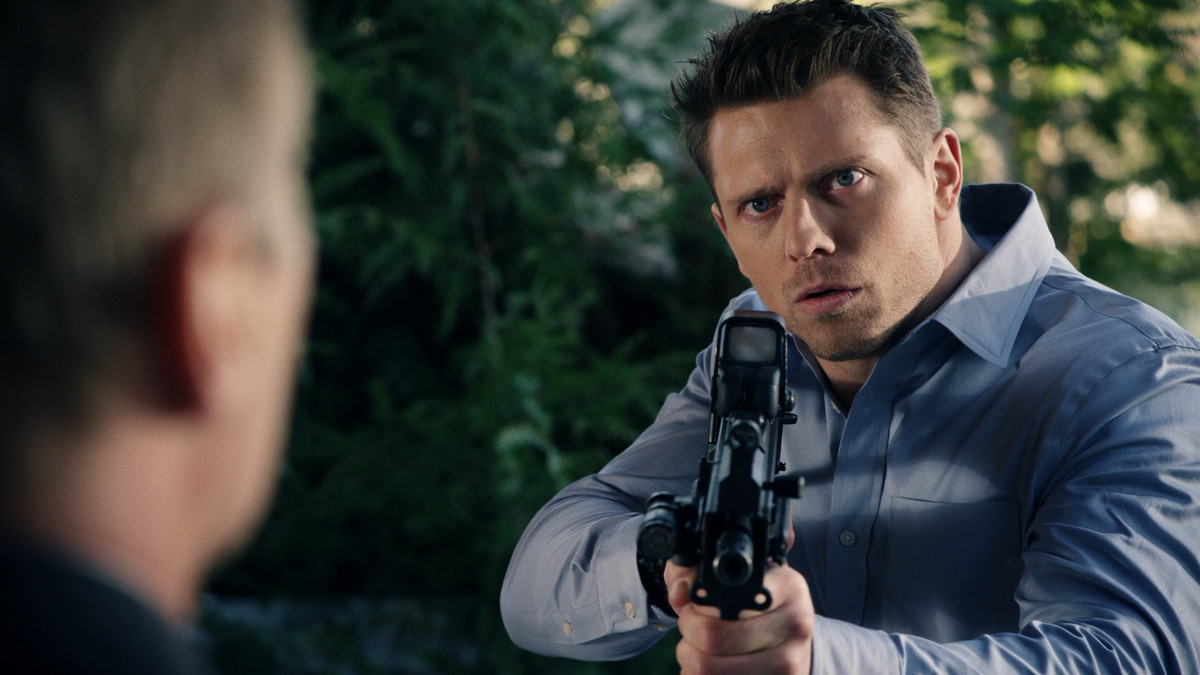 The Miz holds a gun in The Marine 4: Moving Target