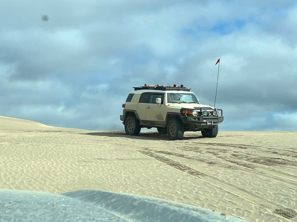 Toyota FJ6 atop dune on Firestone Destinations