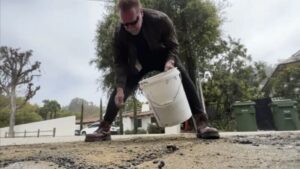 Fed up by L.A. pothole, Arnold Schwarzenegger fills it himself