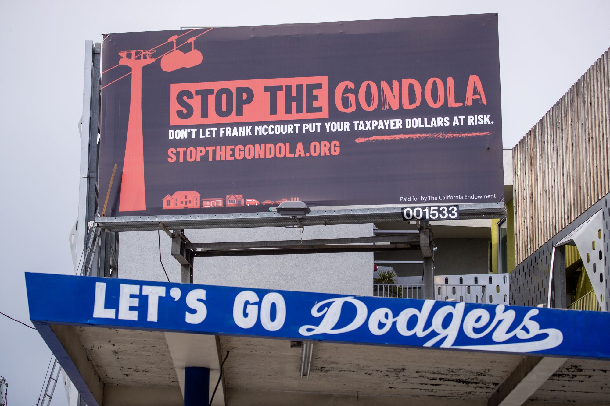 A billboard with the words "Stop the Gondola" above lettering that says "Let's go Dodgers."
