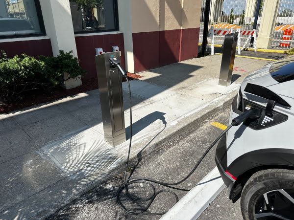 Detachable-cord Level 2 EV charger charging a vehicle