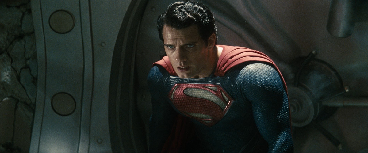 Henry Cavill in Man of Steel, wearing his Superman outfit and hunched over, exhausted