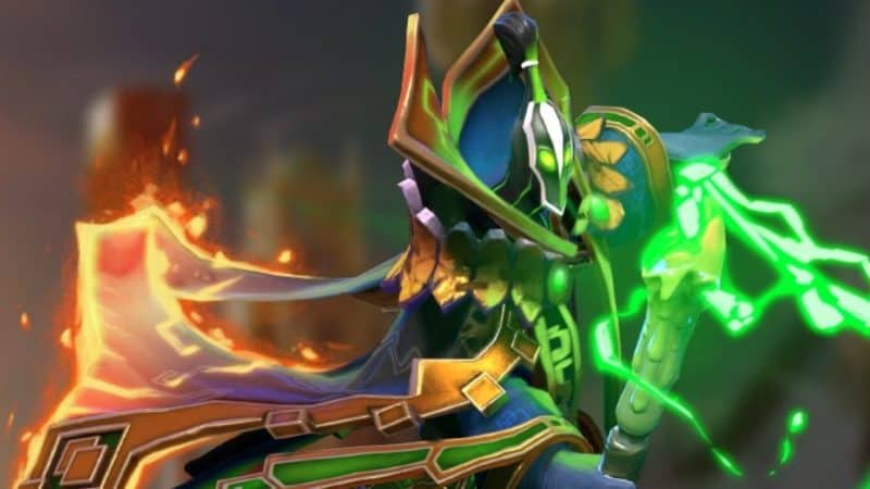 The Dota 2 Hero Rubick casts a spell, his staff crackling with green electricity