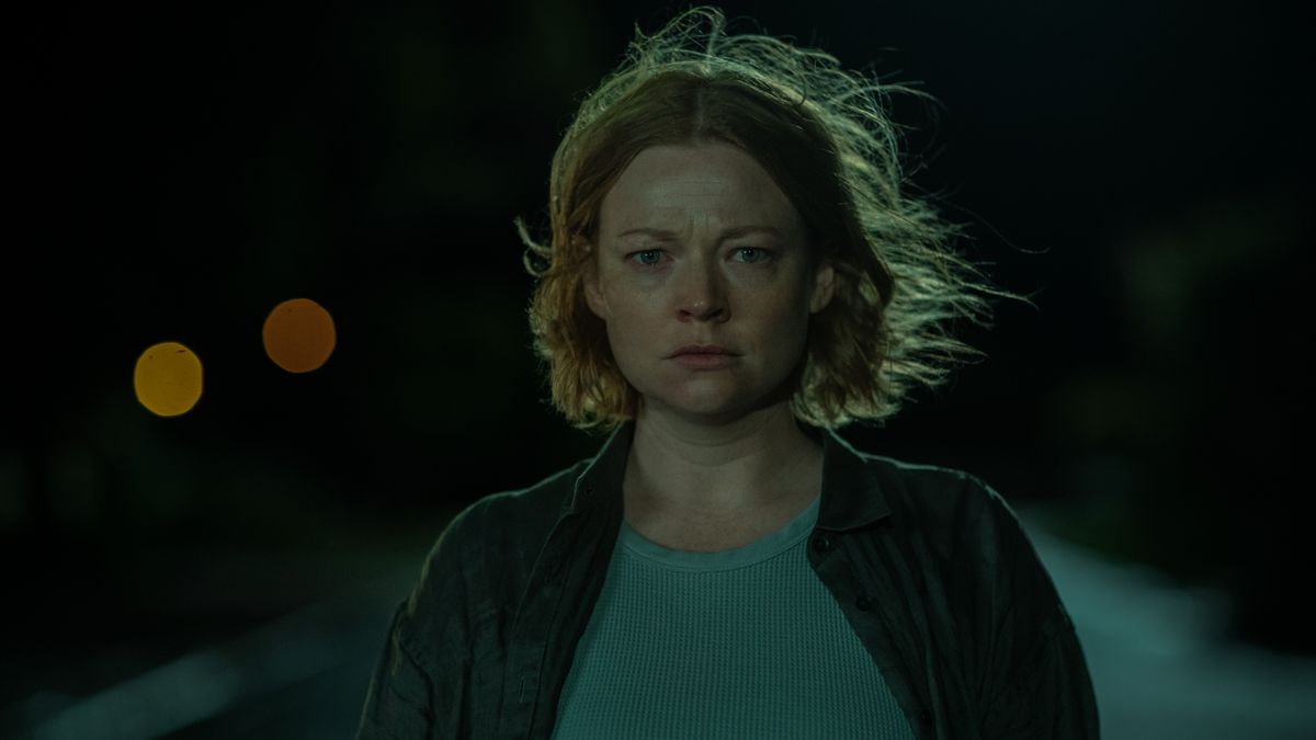 Sarah Snook as Sarah stand in a street in the middle of night looking visibly distressed in Run Rabbit Run.