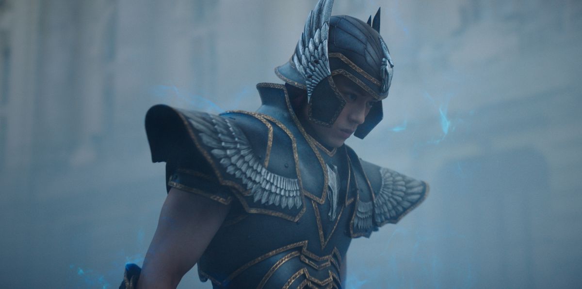 Seiyu (Mackenyu), the protagonist of Knights of the Zodiac, looks determined in his grey armor against a grey background in a grey world