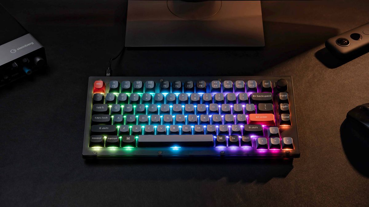A product photo of the Keychron V1 QMK with its RGB backlighting on.