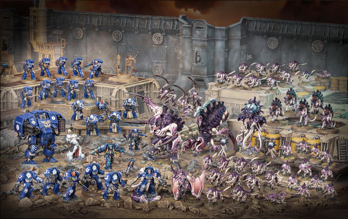 The complete Warhammer 40,000: Leviathan boxed set includes 72 miniatures, displayed here on plastic terrain that does not come with the set. Space Marines are blue, and Tyrannids are purple and pink. The scene is set along a large battlement.