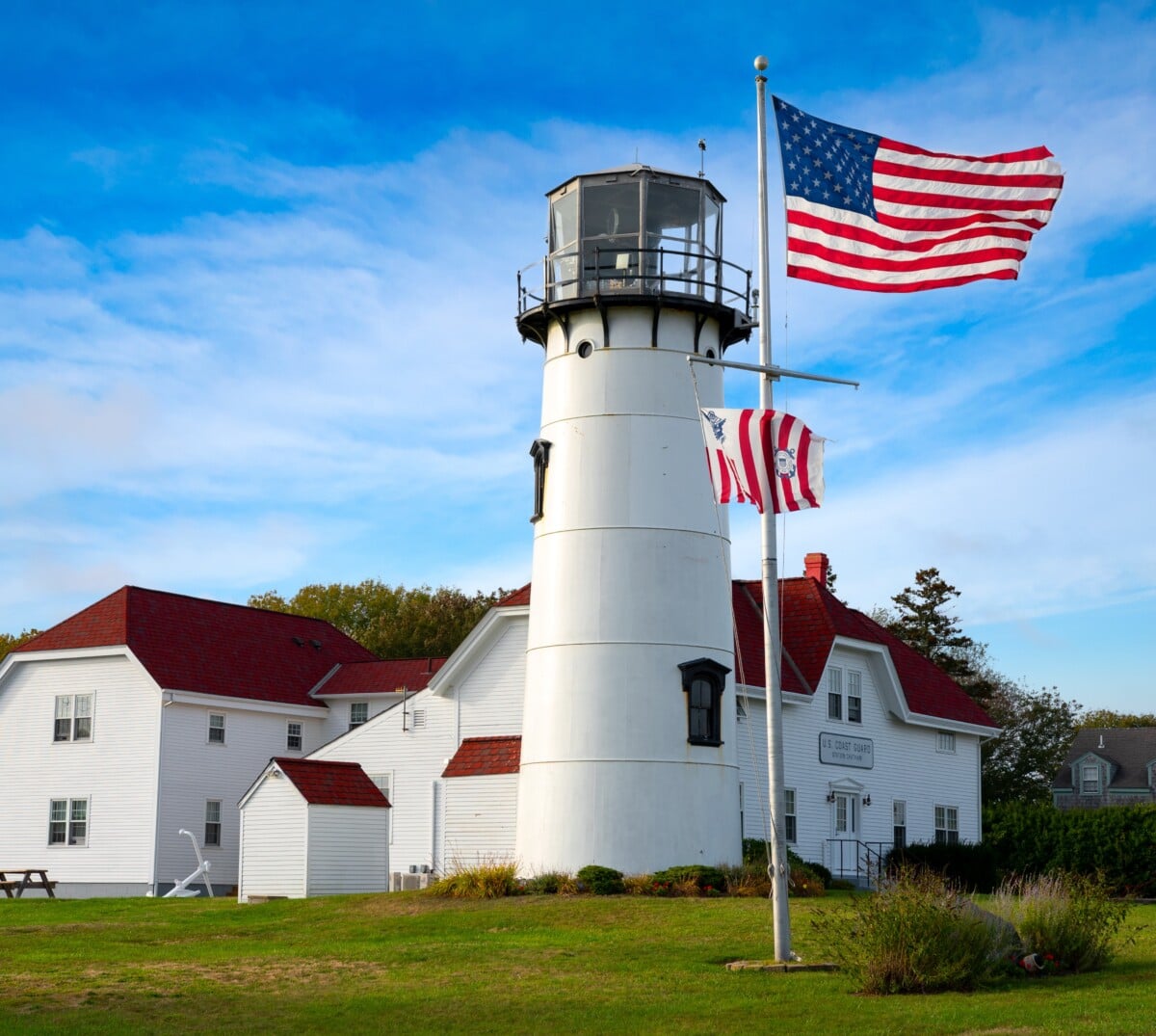 lighthouse with american flag in chatham ma