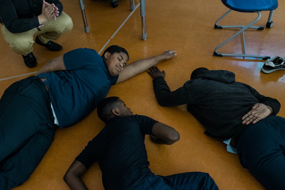 . Students relax on the floor as part of a mindfulness exercise led by Cruz.