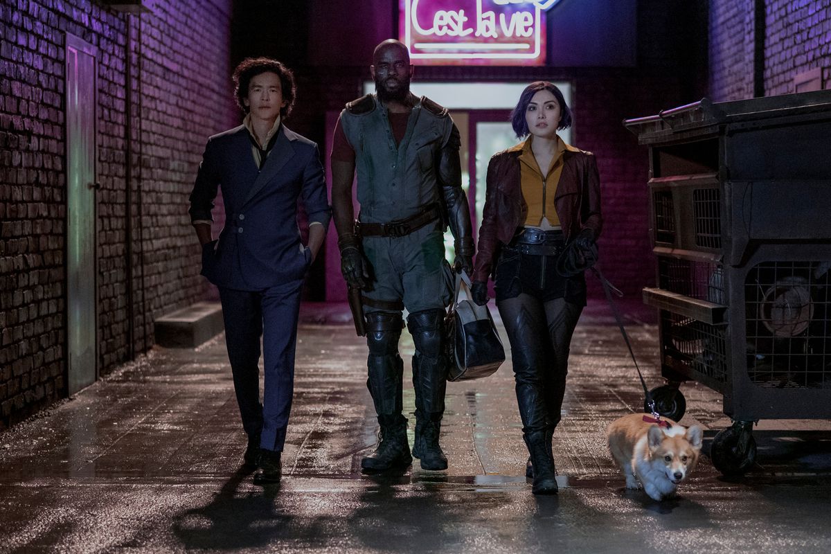 The cast of Netflix’s Cowboy Bebop adaptation: Spike (John Cho), Jet (Mustafa Shakir), and Faye (Daniella Pineda), the latter of whom has Ein on a leash