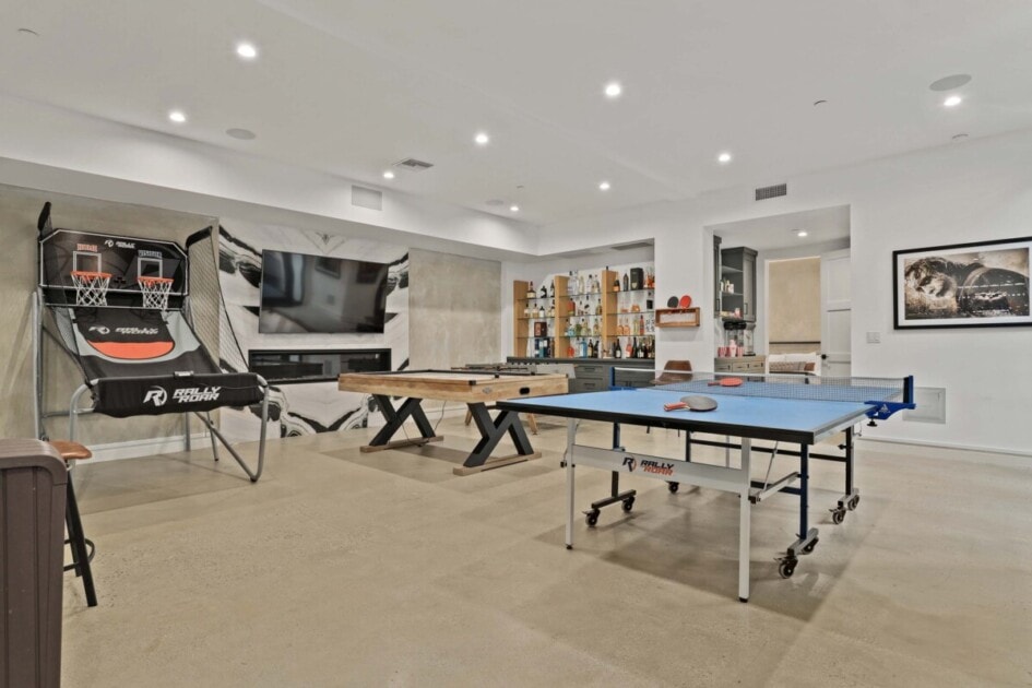 Pool and table tennis set up in a large basement