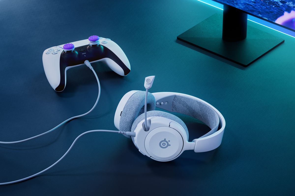 An image showing the SteelSeries Arctis Nova 1P connected to a Sony DualSense controller. This image contains the white and grey color scheme of the Nova 1P headset.
