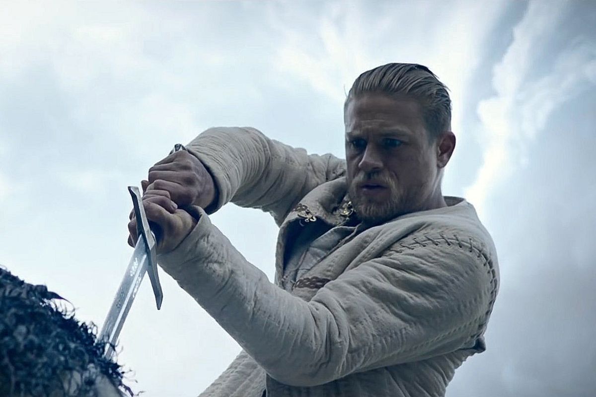 Charlie Hunnam as Arthur pulling Excalibur from the stone in King Arthur: Legend of the Sword.