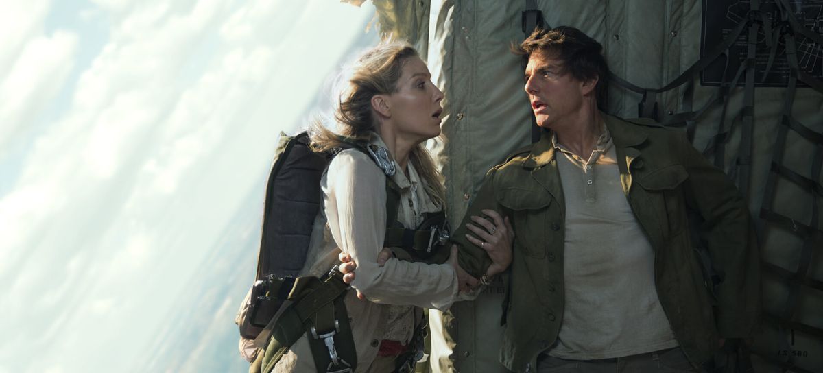 Annabelle Wallis holds onto Tom Cruise on an open cargo plane in The Mummy.