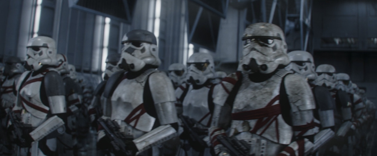 Rows upon rows of storm troopers stand at attention in dirty, armor patched with plates of gold and silver, and wrapped in lengths of red fabric in Ahsoka. 
