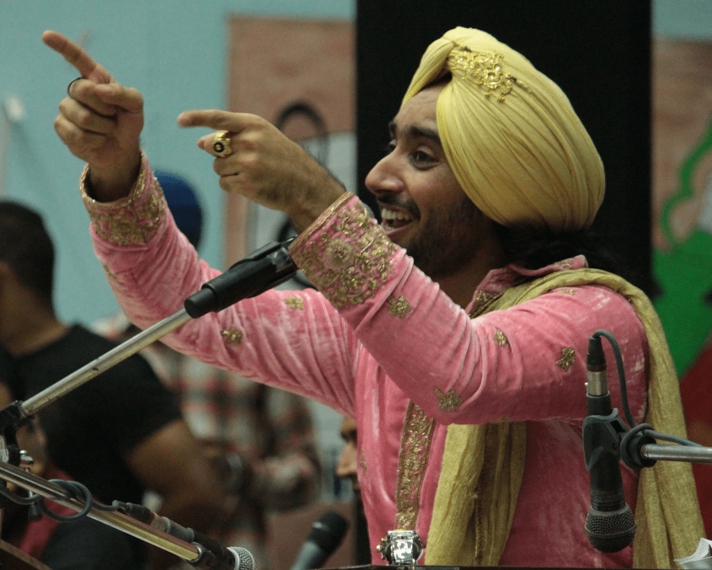 a portrait of artist Satindar Singh Sartaj singing. 