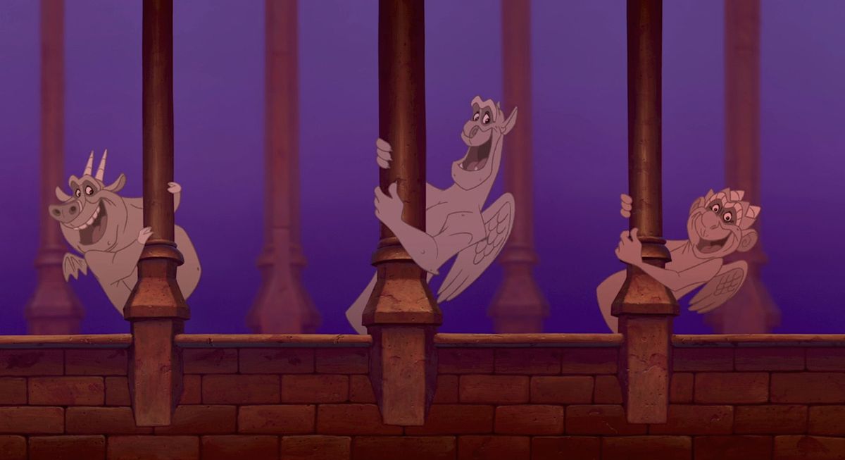 Victor, Hugo, and Laverne, the gargoyles from Disney’s 1996 animated movie The Hunchback of Notre Dame, all give big grins as they hang off stone columns in Notre Dame