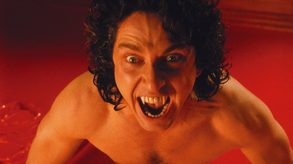 Gerard Butler as Dracula, emerging from a pool of red viscous liquid and barring his fangs in Dracula 2000.
