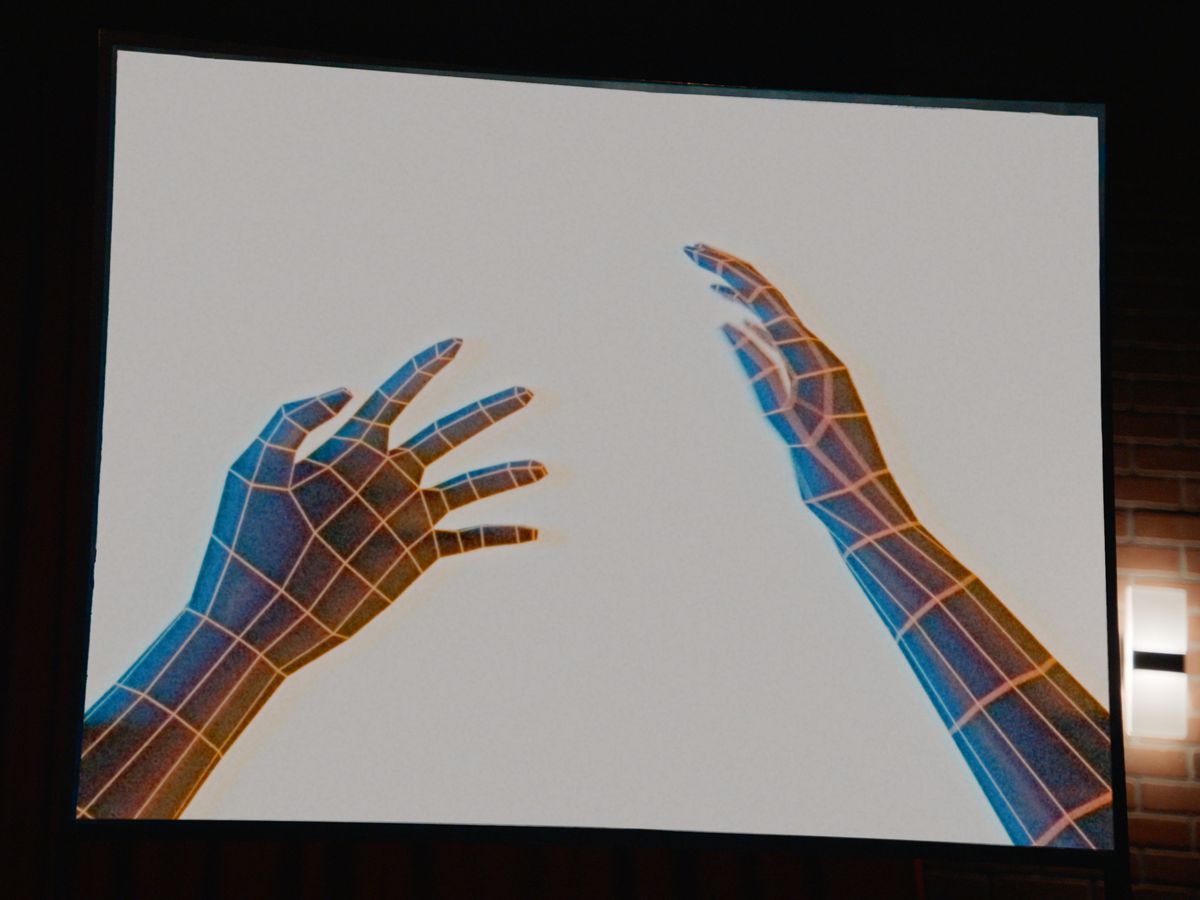 Two simple wireframe hands, extended outward as if from the point of view of someone holding up their hands in front of them, in a CG image from the V/H/S/85 segment TKNOGD