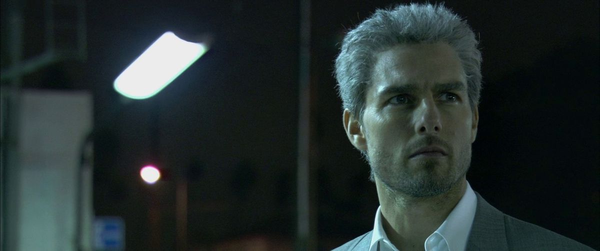 Tom Cruise looks dramatically off in the distance in a nighttime shot from Collateral.
