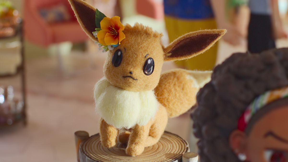 A little Eevee shows off its flower