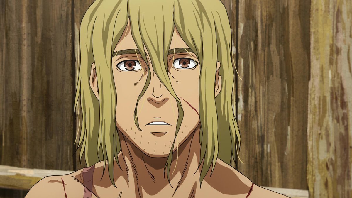 Et nærbilde av en lang blondhåret, brunøyd mann med synlige kutt i ansiktet og hårstrå på haken.