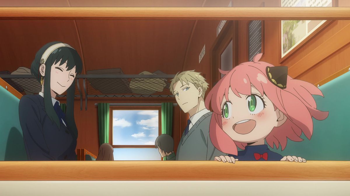 (L-R) Yor, Loid, and Anya Forger sitting in the passenger car of a train overlooking a window in Spy x Family season 2.