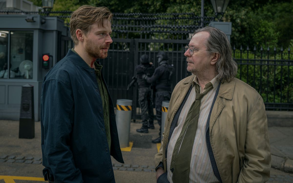 Jack Lowden and Gary Oldman talk in front of a secure area in Slow Horses