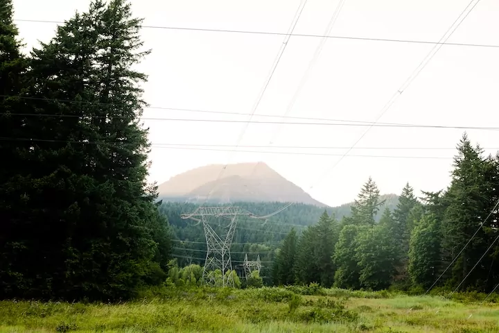 Power lines with mountains and trees